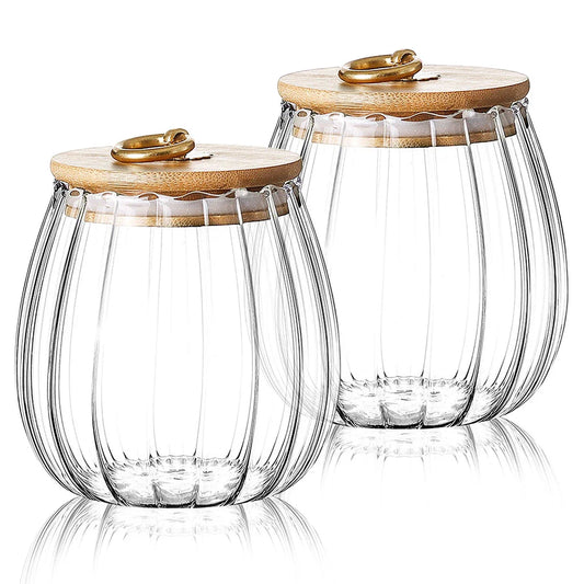 Elegant glass canisters with flower-shaped metal handles and airtight bamboo lids for stylish kitchen storage