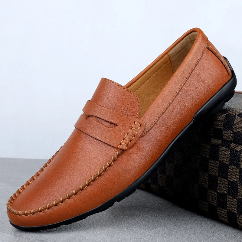 Men's driving shoes in black cowhide leather with sleek, round-toe design for superior driving control and style