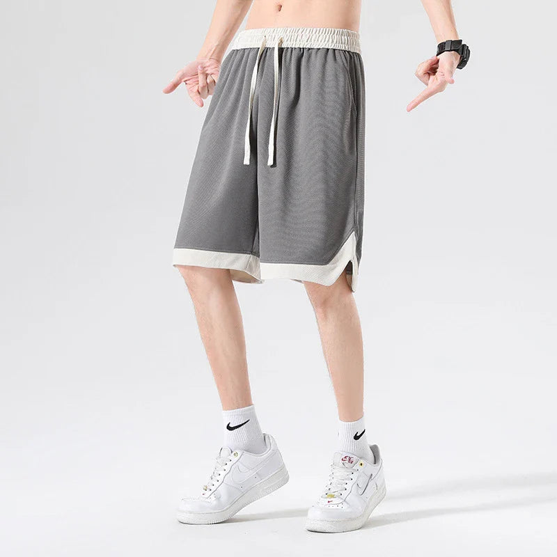 Men's loose and comfortable sports pirate shorts in white, gray, and black colors with elasticized waistband and relaxed fit