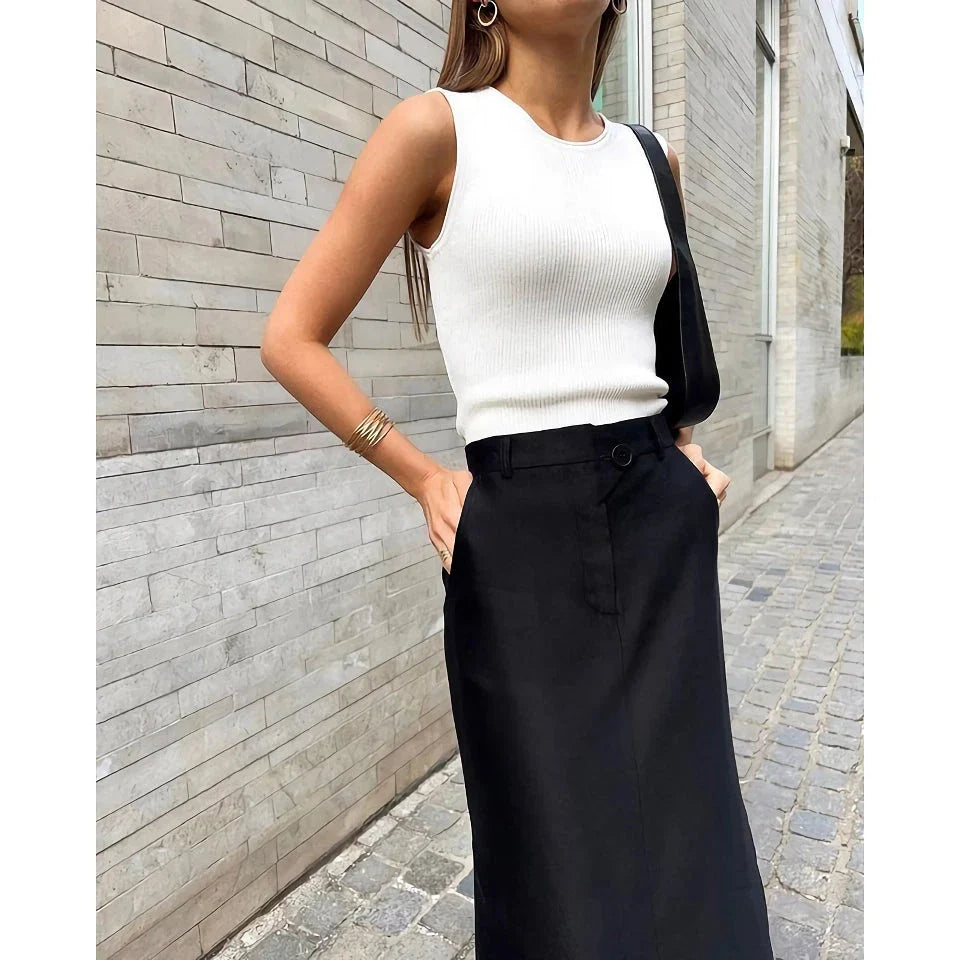 Elegant black ankle-length a-line skirt with pockets, made from a premium blend of polyester, spandex, and viscose for a comfortable, non-stretch fit.