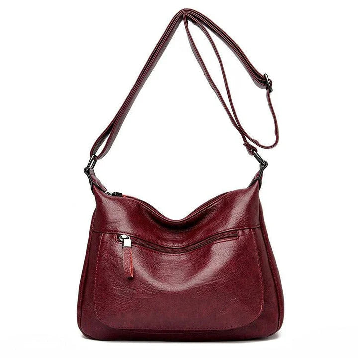 Stylish one-shoulder messenger bag in various colors with a soft, supple PU leather exterior and a spacious, organized main compartment