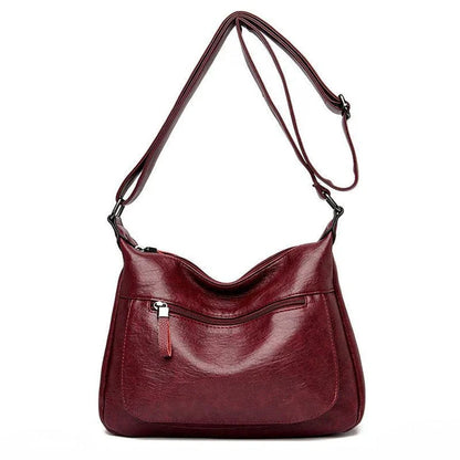 Stylish one-shoulder messenger bag in various colors with a soft, supple PU leather exterior and a spacious, organized main compartment