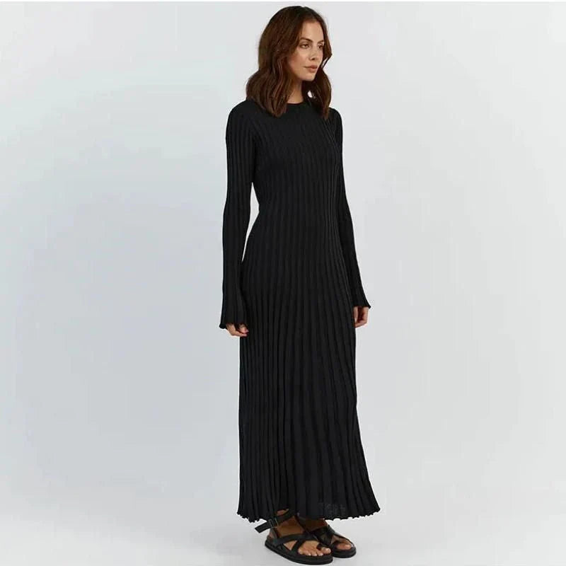 Timeless elegant pleated knit dress in black, perfect for summer office wear with a sophisticated and comfortable design.
