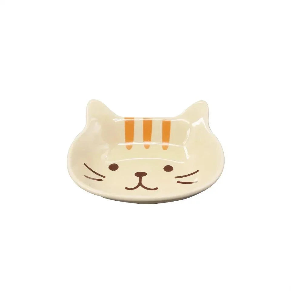 A charming Japanese-style ceramic dish featuring a cute cat design, perfect for serving sauces, dips, and small portions in style.