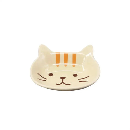 A charming Japanese-style ceramic dish featuring a cute cat design, perfect for serving sauces, dips, and small portions in style.