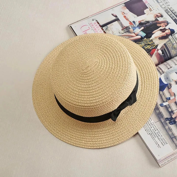 Classic straw Panama hat with a bow detail, offering sun protection and fashionable summer style