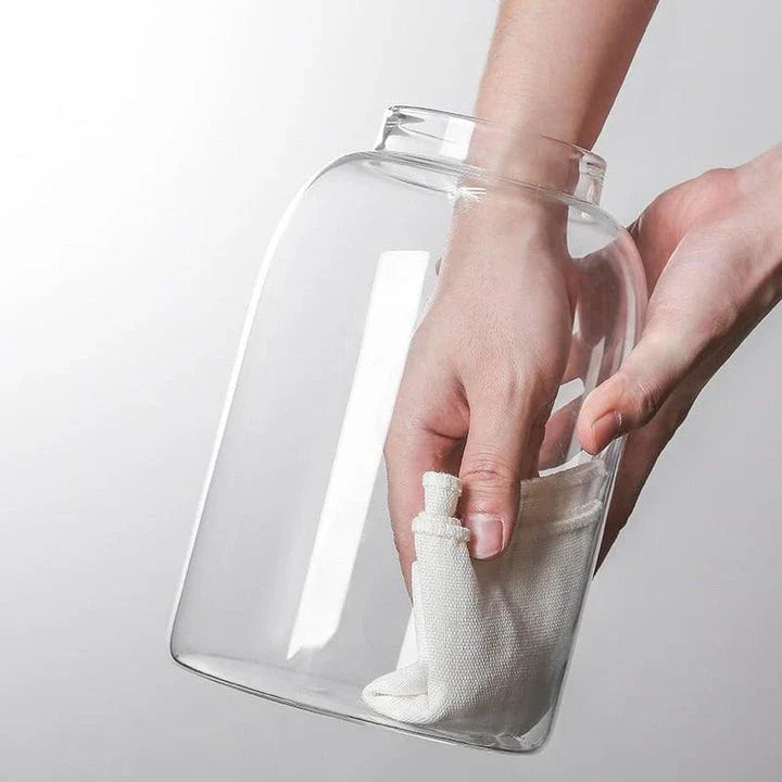 Airtight glass food storage jars with wooden lids in various sizes, perfect for organizing and preserving dry goods, spices, and pantry items in the kitchen.