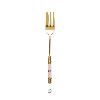 Elegant gold-plated dessert fork with intricate ceramic handle design