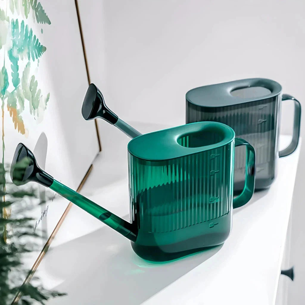 A large, dark grey gardening watering can with a long spout and sprinkler head for efficient, hassle-free plant watering