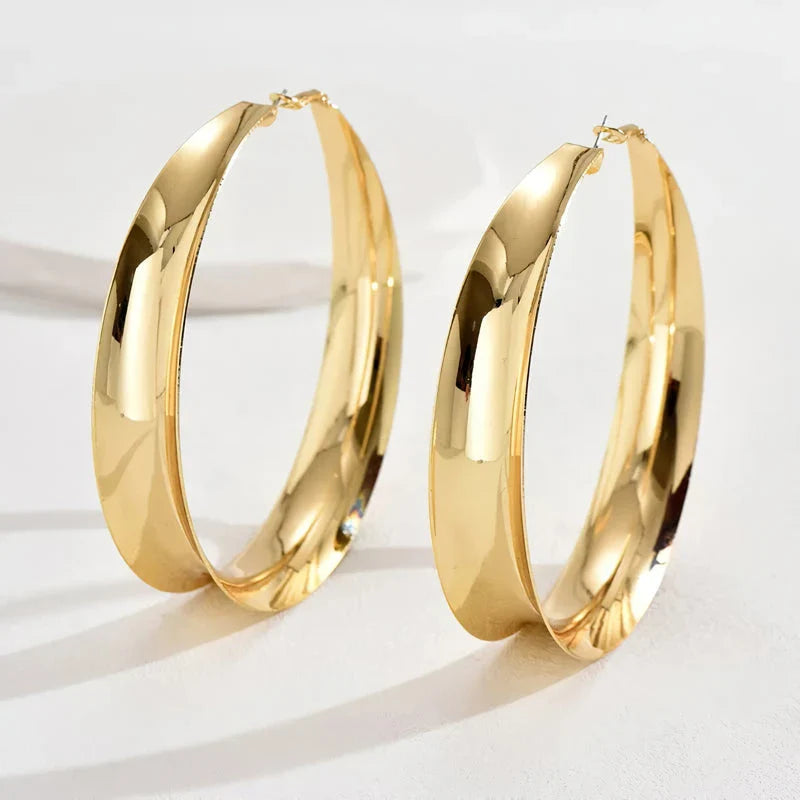 Glossy geometric metal hoop earrings in a silver finish, a trendy and versatile fashion accessory