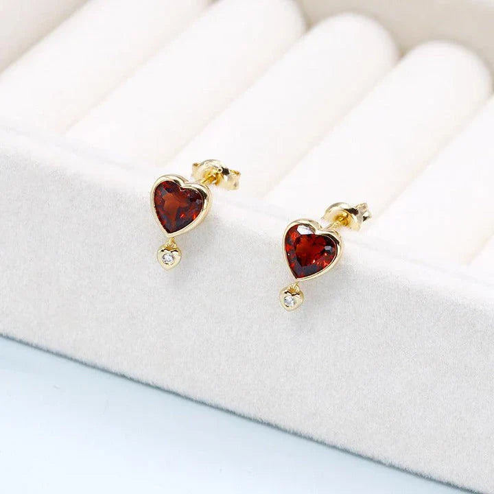 Elegant heart-shaped earrings with natural garnet and zircon stones in a pomegranate color, showcasing a timeless, versatile design.