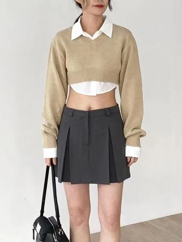 A cozy, knitted pullover sweater with a timeless round neck design, available in a versatile camel color.