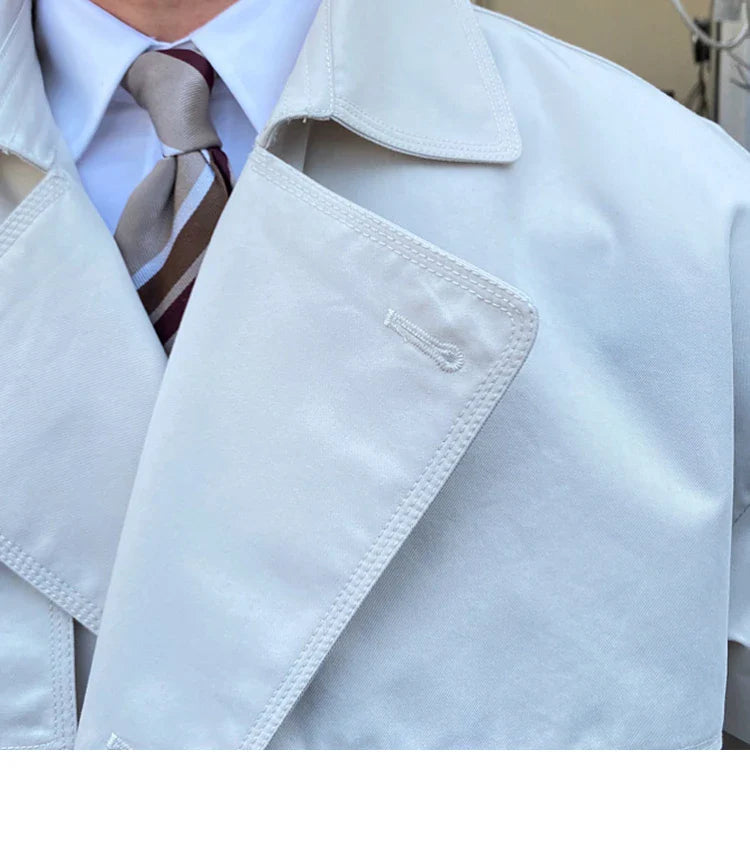 Commuter-friendly mid-length trench coat with double-breasted lapels, made from durable cotton-polyester blend fabric