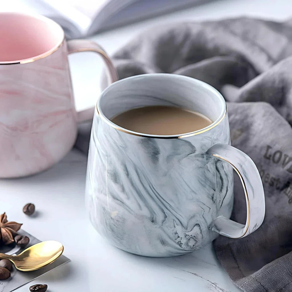 Elegant marble pattern ceramic mug with a gold rim, perfect for coffee, tea, and other hot and cold beverages