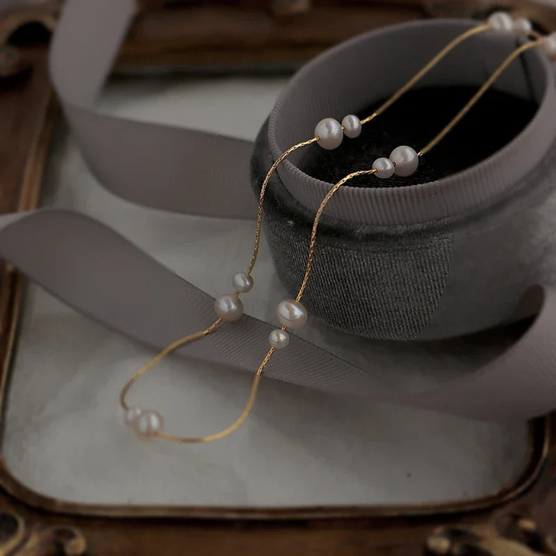 Elegant mother-of-pearl necklace with delicate butterfly and dragonfly motifs, inspired by Asian design