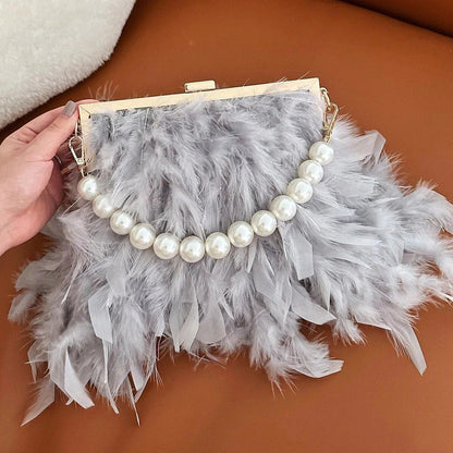 Elegant feather clutch bag with pearl embellishments and metal chain details