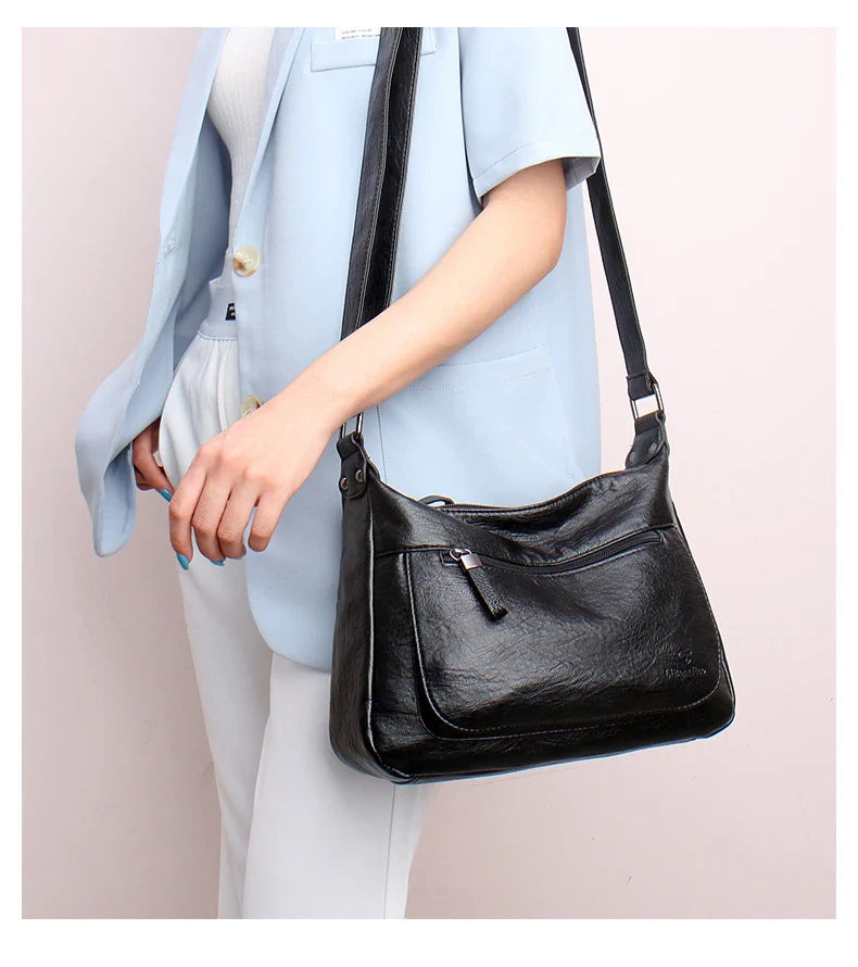 Stylish one-shoulder messenger bag in various colors with a soft, supple PU leather exterior and a spacious, organized main compartment
