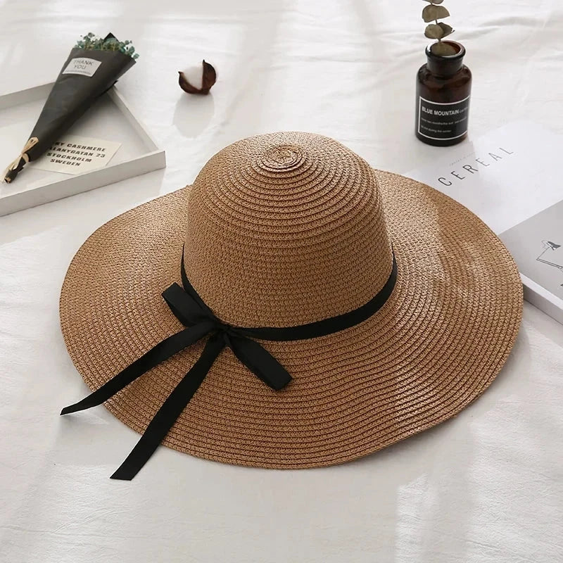 Fashionable summer straw hat for women with wide brim and bow detail, providing UV protection and stylish look