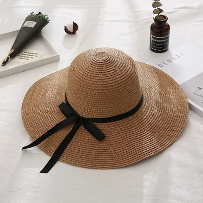 Fashionable summer straw hat for women with wide brim and bow detail, providing UV protection and stylish look