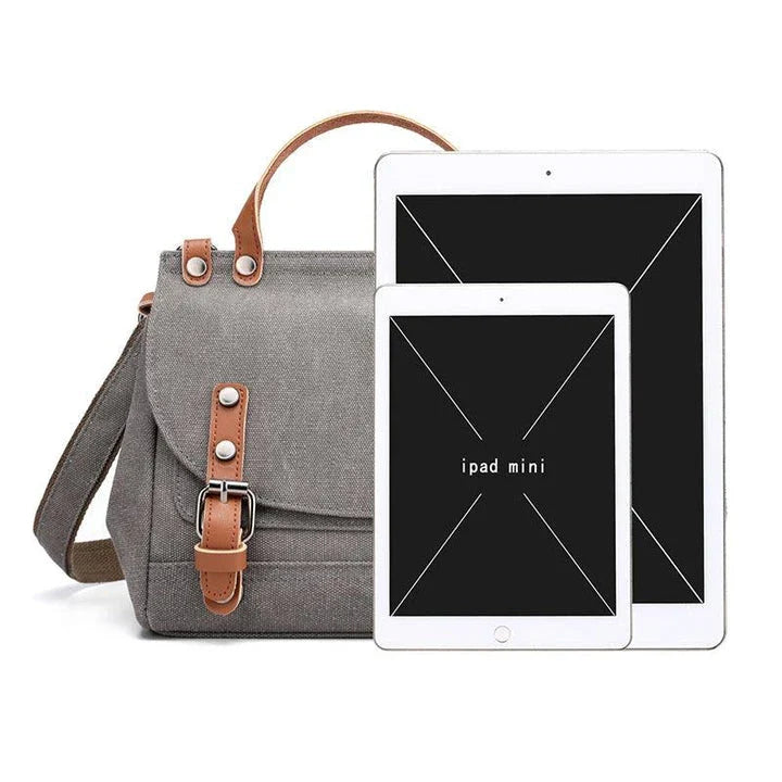 A stylish women's canvas crossbody handbag in an orange color, featuring a small square shape and a horizontal design.