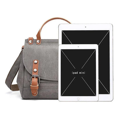 A stylish women's canvas crossbody handbag in an orange color, featuring a small square shape and a horizontal design.