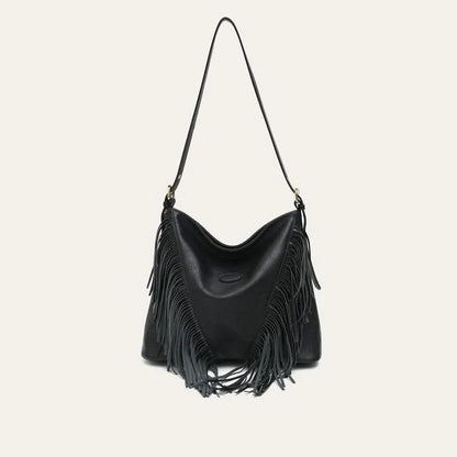 Chic vegan leather shoulder bag with tassel decoration, featuring a spacious interior and versatile carrying options