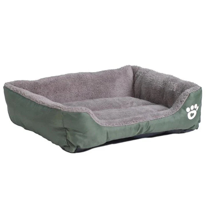 A plush, green pet bed with a paw-print pattern, designed to provide cozy and waterproof comfort for pets.
