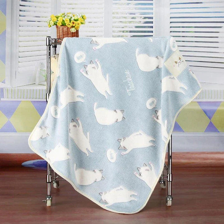 Cozy oversized fleece blanket in light blue and pink colors, suitable for both human and pet use