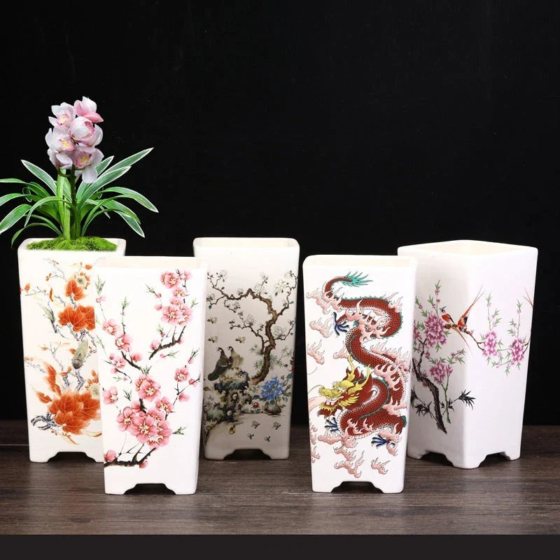 Elegant square ceramic planter in white with a Chinese-inspired design, suitable for indoor plants like asparagus fern and orchid.