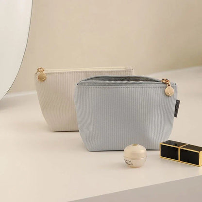 Mini portable waterproof cosmetic bag in beige and gray colors with a foldable design for convenient storage