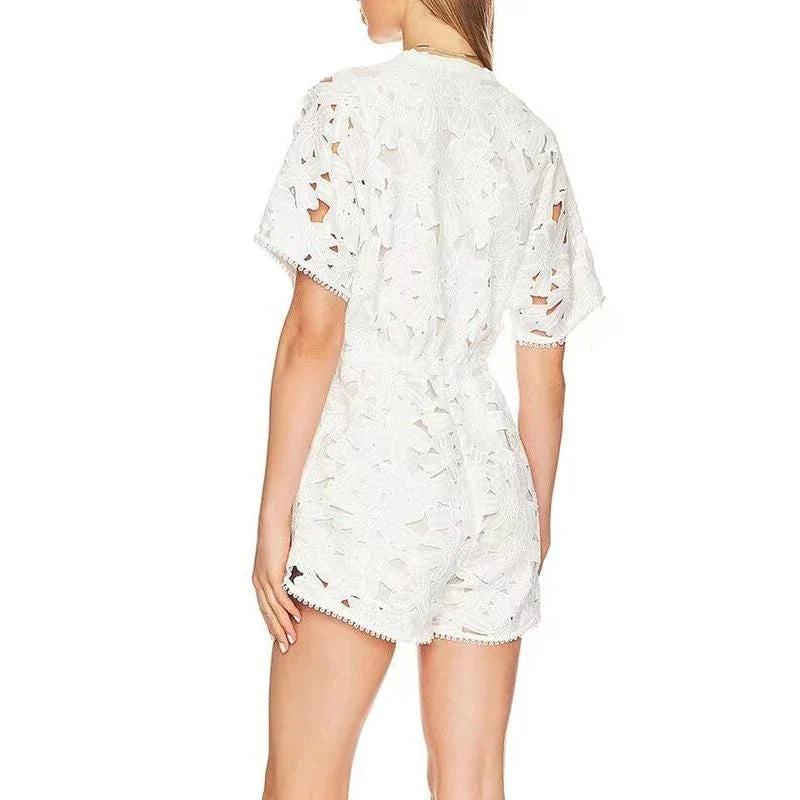 Chic embroidered hollow-out summer playsuit with a V-neck, high waistline, and short sleeves for a stylish and comfortable vacation or casual look.