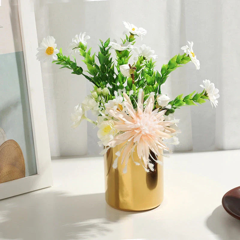 Elegant gold stainless steel desk organizer holding pens, pencils, and makeup brushes on a modern workspace