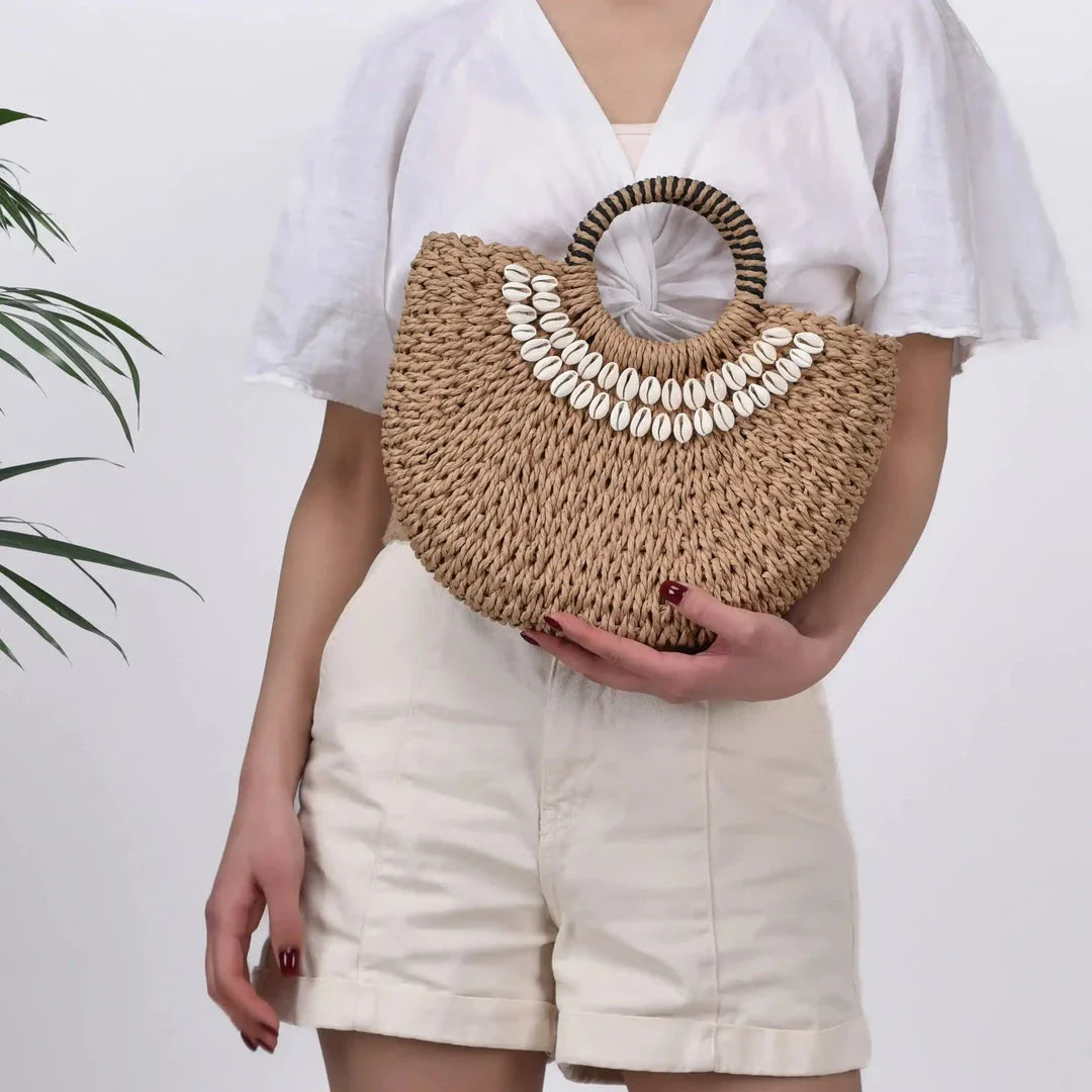 Handmade straw woven crossbody handbag with seashell accents, perfect for summer beach and resort wear