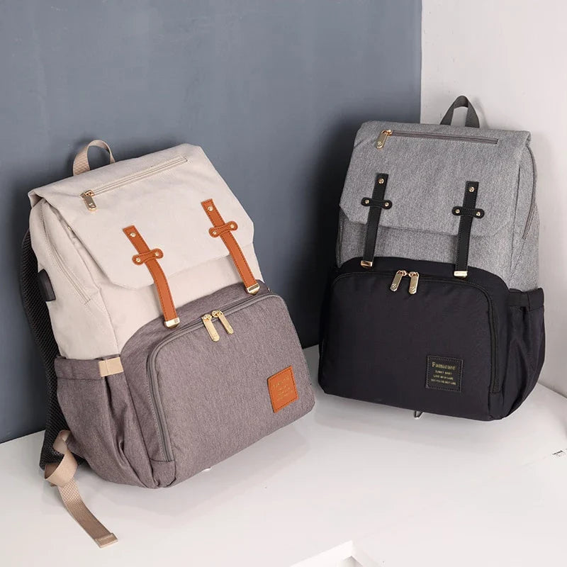 Premium diaper backpack with insulated pockets, stroller attachment, and USB charging port