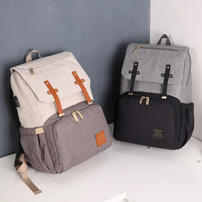 Premium diaper backpack with insulated pockets, stroller attachment, and USB charging port