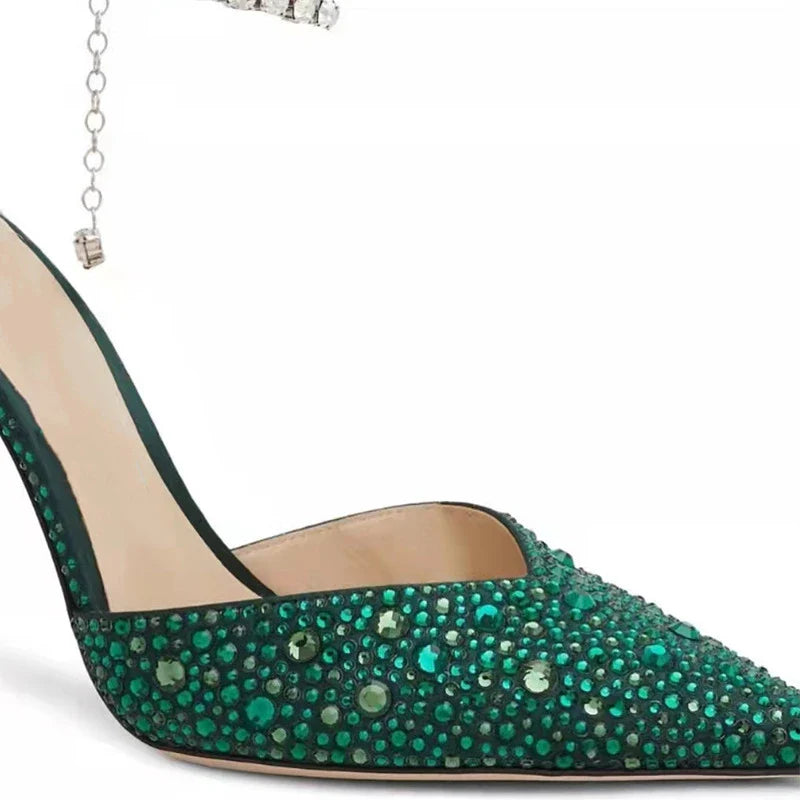 Glamorous rhinestone-embellished stiletto sandals in black and green colors, featuring a pointed toe and sleek silhouette
