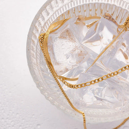 Elegant 18K gold plated stainless steel flat snake chain necklace with letter charms, a timeless accessory for modern fashion.