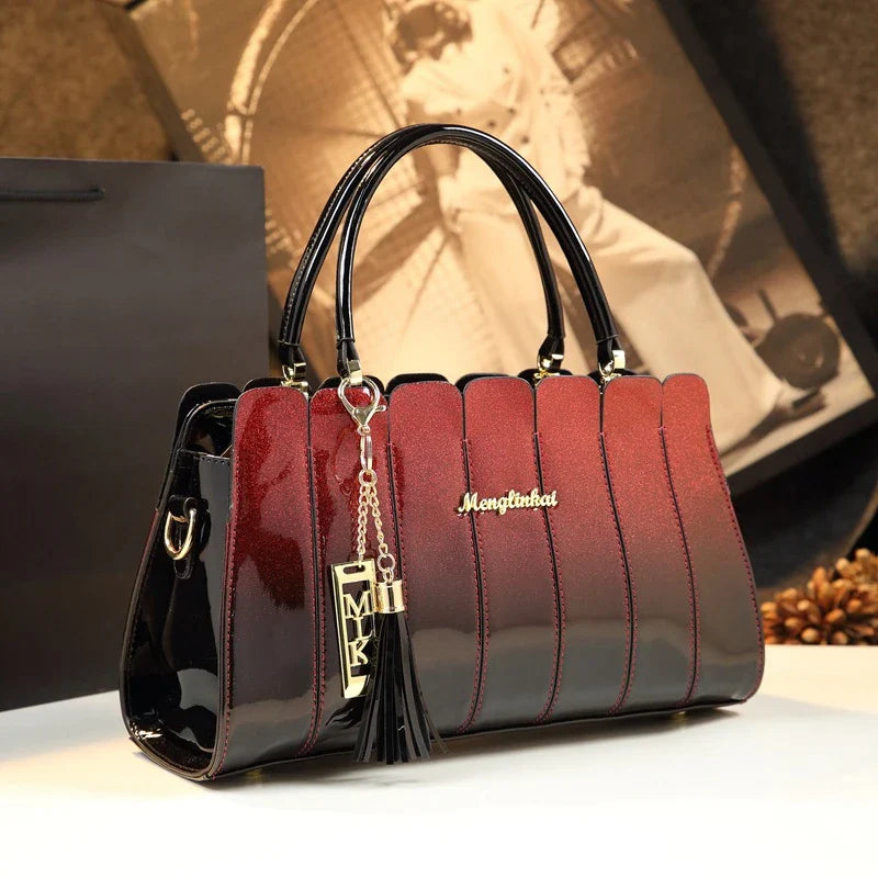 Premium patent leather crossbody handbag in fuchsia color with multiple pockets for organization and adjustable strap for hands-free convenience