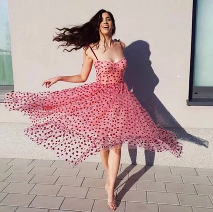 A stylish polka dot dress with a bandeau waist and flared skirt, perfect for elegant occasions or everyday wear.