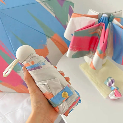 Compact UV Protection Mini Travel Umbrella with black coating and folding design for easy portability