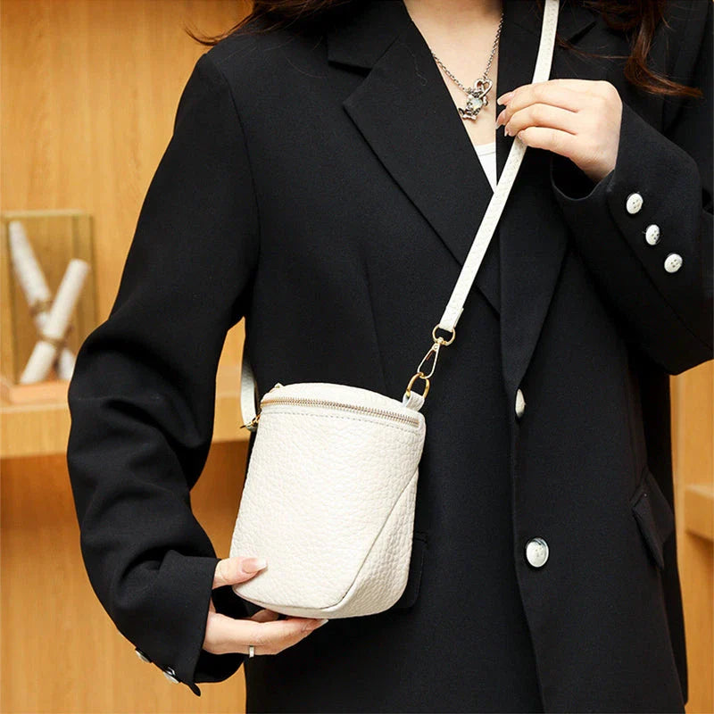 Premium leather crossbody bag with adjustable strap, multiple pockets, and sleek Korean-inspired style