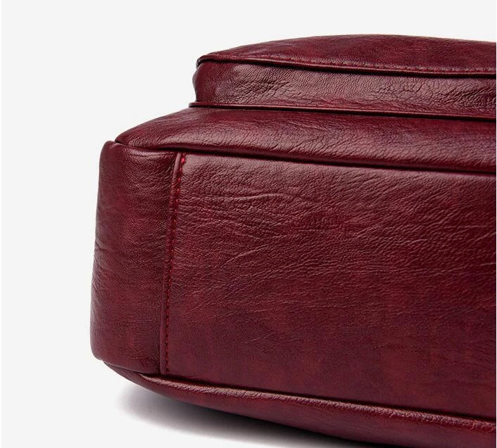 Stylish one-shoulder messenger bag in various colors with a soft, supple PU leather exterior and a spacious, organized main compartment