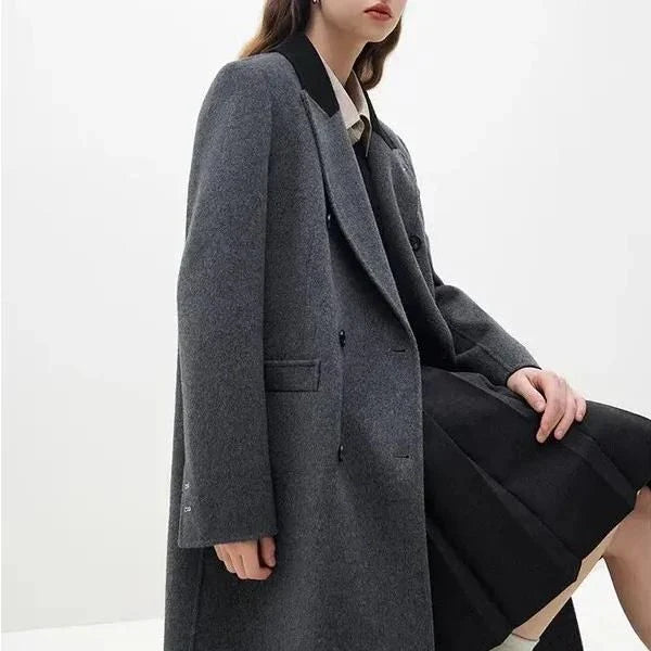 A luxurious 100% wool women's long grey coat with a timeless double-breasted design and stylish notched collar