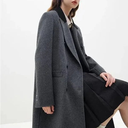 A luxurious 100% wool women's long grey coat with a timeless double-breasted design and stylish notched collar