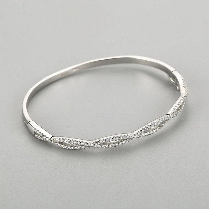 Elegant silver bracelet with a captivating wave-like design, a premium micro-set jewelry piece crafted with superior Seiko technology