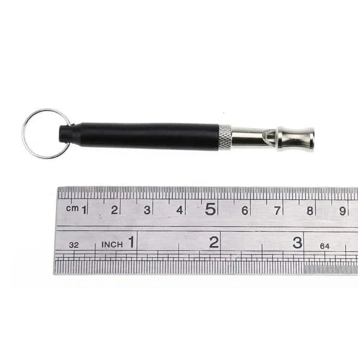 Compact dog training whistle made of metal and plastic with a black and silver design