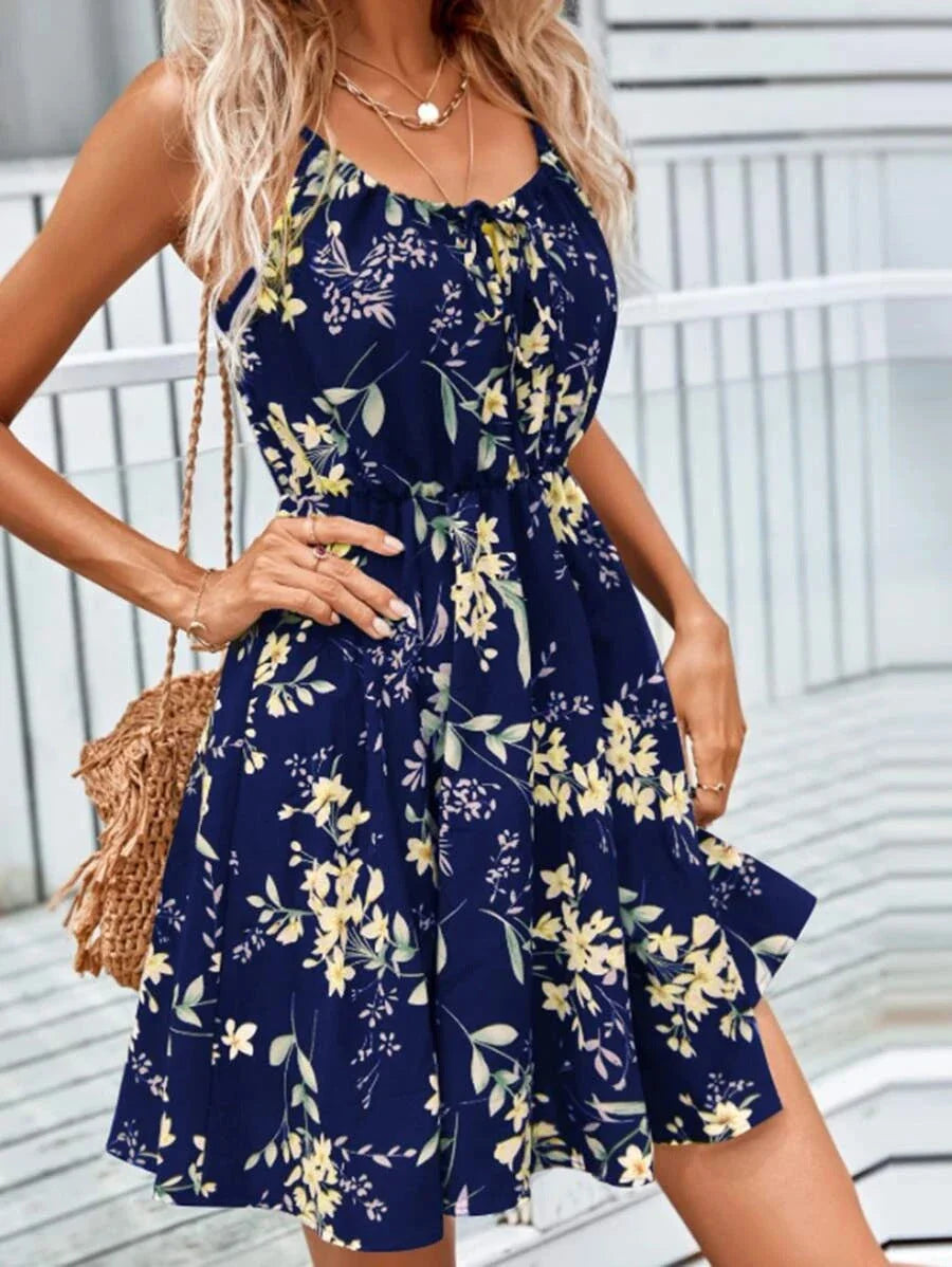 A stylish floral print suspender dress with an elastic waist, perfect for summer fashion and casual or dressy occasions.
