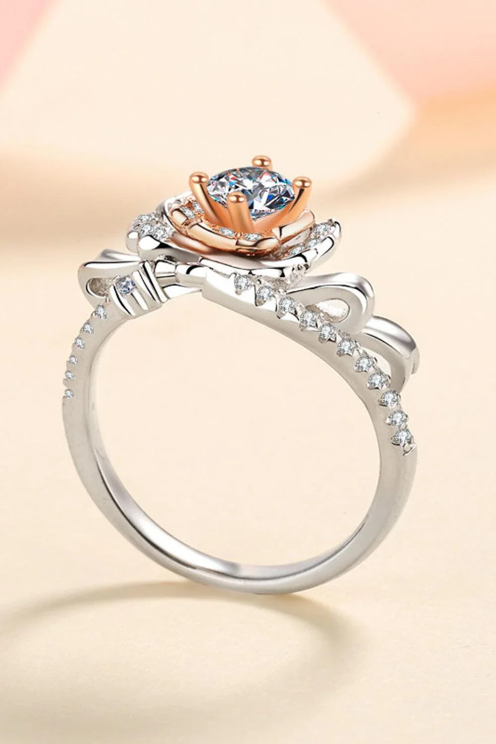 Elegant rose-shaped moissanite ring in sterling silver with a sparkling center stone and zircon accents