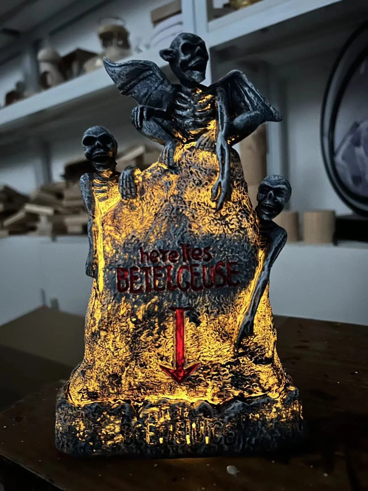 Glowing ghost skull tombstone decor with a spooky, otherworldly glow for Halloween