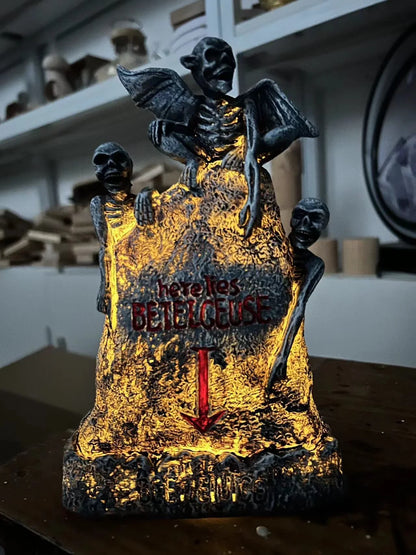 Glowing ghost skull tombstone decor with a spooky, otherworldly glow for Halloween